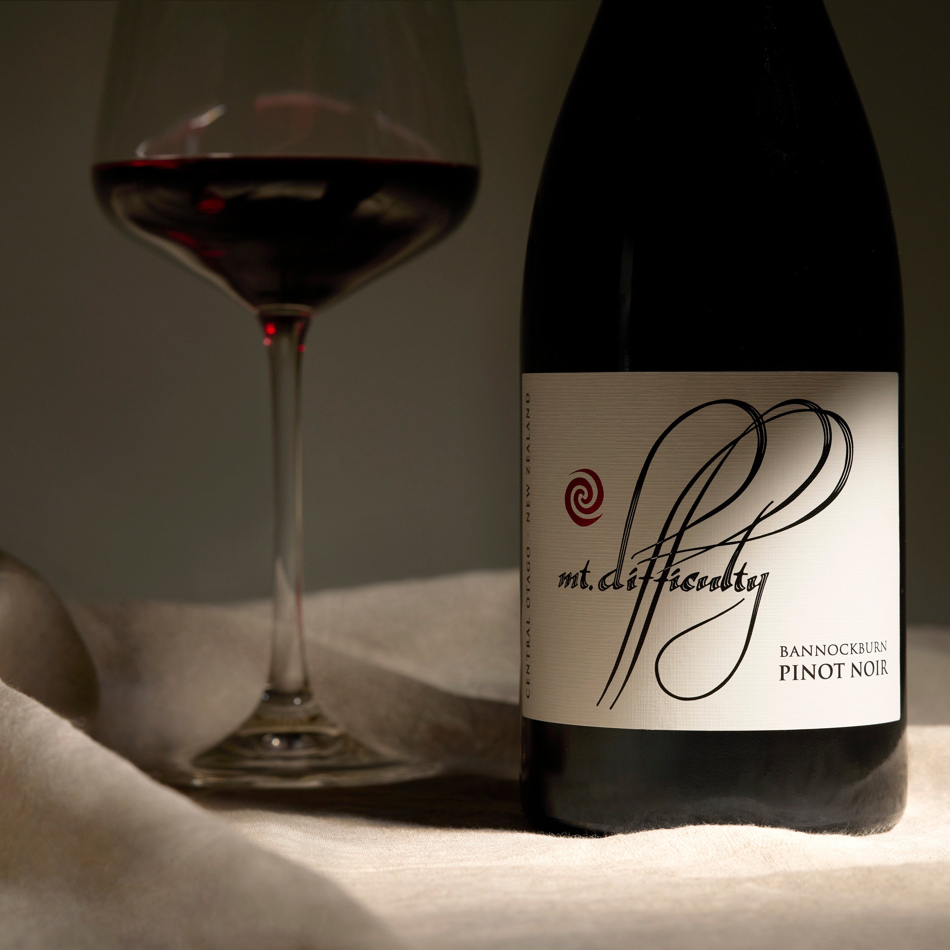 Mt Difficulty Bannockburn Pinot Noir and Glass Red Wine on Blanket